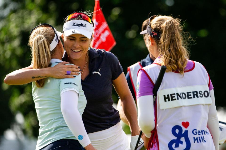 Lexi Thompson (middle) hugs Brooke Henderson (left) after they complete the Meijer LPGA Classic Sunday, June 19, 2022, at Blythefield Country Club in Belmont Michigan. Thompson finished the tournament -16 under and Henderson -15. 