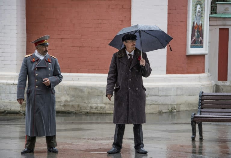 Two faces of history: Impersonators of Soviet Union founder Vladimir Lenin (r) and Soviet leader Joseph Stalin in downtown Moscow ahead of the Russian revolution centenary