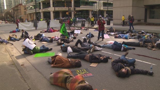 Protesters with Extinction Rebellion lay on a road in downtown Vancouver on Feb. 27, 2021.