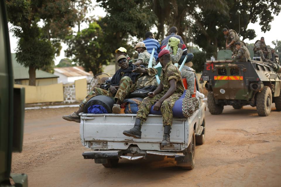 Seleka Muslim militias evacuate the Camp de Roux downtown Bangui, Central African Republic, Monday Jan. 27, 2014, to relocate and join other Selekas at the PK11 camp. The clearing out of Camp de Roux — normally the army's main base in the capital — comes more than two weeks after rebel leader-turned-president Djotodia surrendered power amid mounting international condemnation of his inability to stop sectarian bloodshed. A new interim civilian government has pledged to halt the violence and attempt to organize elections no later than February 2015. (AP Photo/Jerome Delay)