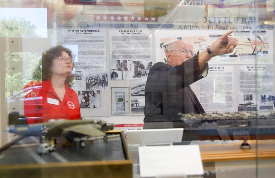 Librarian Janice Henderson and Frank Goldstein point out some of the significant pieces in the Doolittle Raiders exhibit in the lobby of Raider Arena at Northwest Florida State College.