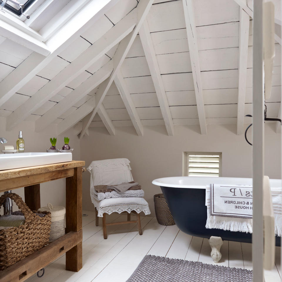 Loft bathroom with wooden flooring and ceiling panelling