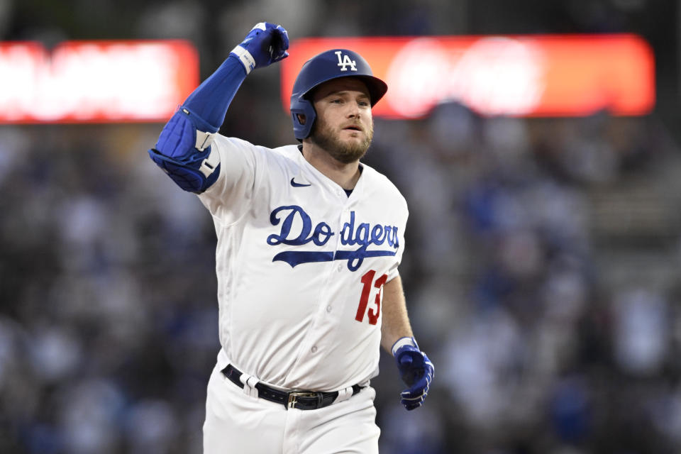 Los Angeles Dodgers' Max Muncy celebrates while rounding second base on a solo home run against the Cincinnati Reds during the sixth inning of a baseball game in Los Angeles, Saturday, July 29, 2023. (AP Photo/Alex Gallardo)