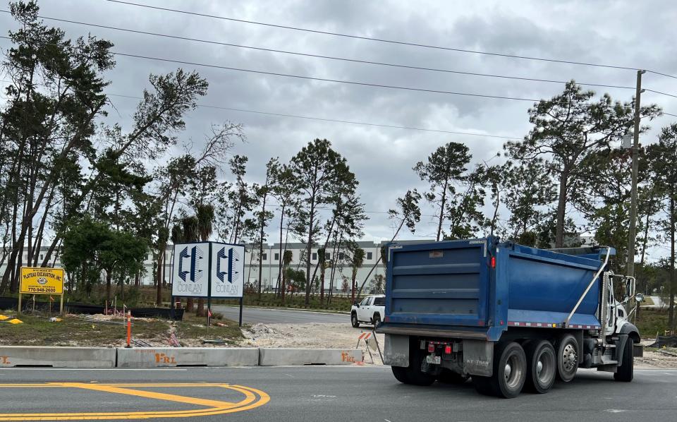 A dump truck enters the construction site for the new I-4 Logistics Park at 2601 N. Normandy Blvd. in Deltona on Wednesday, April 12, 2023. Amazon this week confirmed plans to open a 1 million-square-foot "pre-first-mile" fulfillment center in the park's newly completed building seen in the background. It is across the street from an existing Amazon "first-mile" logistics facility that opened in September 2020 at 2600 N. Normandy Blvd.