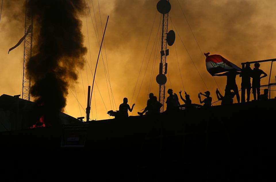 Protesters storm and burn the Basra Government building during a demonstration demanding better public services and jobs in Basra, 340 miles (550 km) southeast of Baghdad, Iraq, Friday, Sept. 7, 2018. Angry protesters stormed the Iranian consulate in the southern city of Basra Friday, setting a fire inside as part of ongoing demonstrations that have turned deadly in the past few days, a security official and eyewitnesses said. (AP Photo/Nabil al-Jurani)