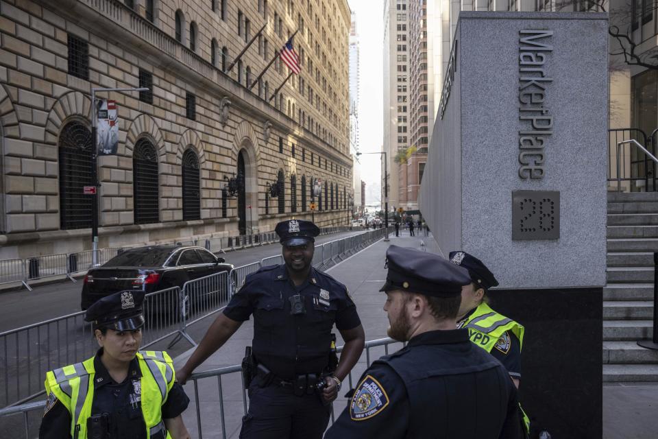 Police officers stand outside an Attorney General's office building for depositions in a civil investigation in New York, Thursday, April. 13, 2023. Former President Donald Trump is expected to visit the offices of New York’s attorney general for his second deposition in a legal battle over his company’s business practices. (AP Photo/Yuki Iwamura)