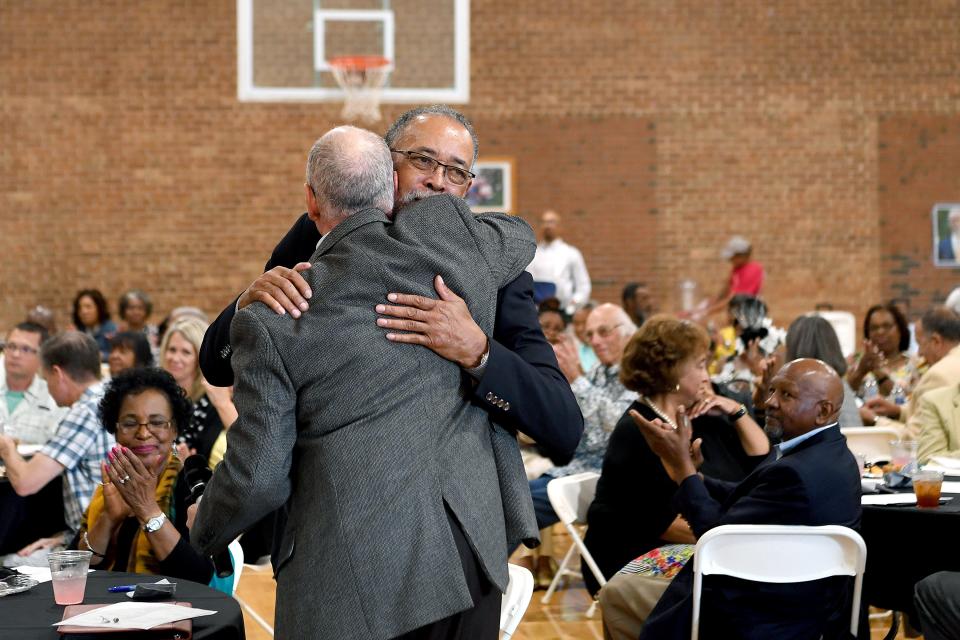 Gene Bell hugs David Nash after Nash presented him with a gift at his retirement party at the Arthur R. Edington Center on July 25, 2019.