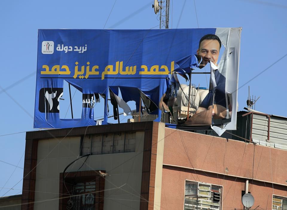 An electoral poster for the upcoming parliamentary elections is seen torn in Baghdad, Iraq, Sunday, Sept. 26, 2021. (AP Photo/Hadi Mizban)