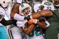 <p>Miami Dolphins running back Kenyan Drake (32) is tackled by New York Jets defensive tackle Deon Simon (93) in the fourth quarter at MetLife Stadium. Mandatory Credit: Dennis Schneidler-USA TODAY Sports </p>