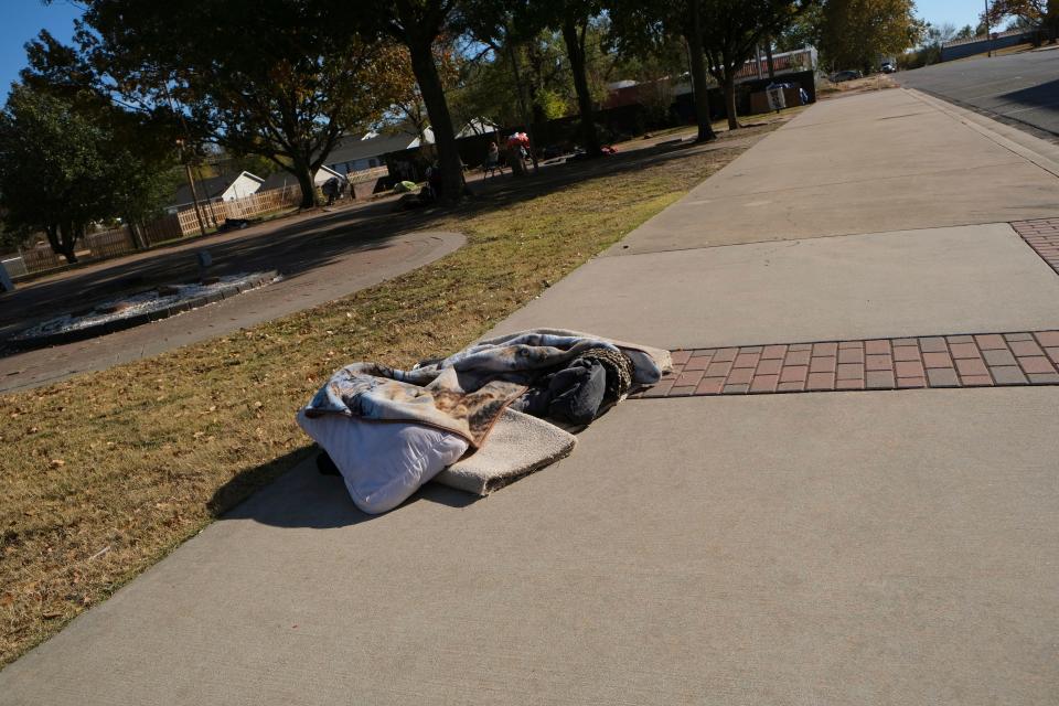 Bedding is left on the sidewalk at Celebration of Life Park, 301 E Main St. in downtown Shawnee, where the homeless gather.