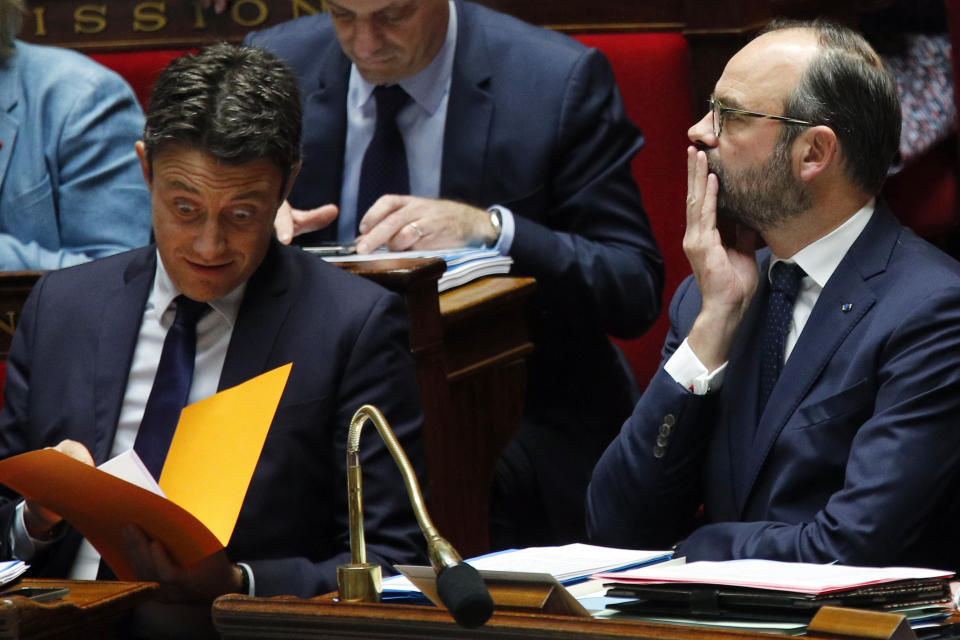 French Government's Spokesperson Benjamin Griveaux, left and French Prime Minister Edouard Philippe attend the French National Assembly's questions to the government in Paris, Wednesday, Jan.16, 2019. France's parliament is expected to adopt a law allowing for emergency measures to deal with Britain's March 29 exit from the EU. The National Assembly is voting Wednesday on the final reading of a special law drafted to handle a 'no-deal' Brexit. The law includes things like extra customs officers after Brexit day, and a temporary rule allowing Britons employed in France to keep their jobs after March 29 even though they will no longer be EU citizens. (AP Photo/Francois Mori)