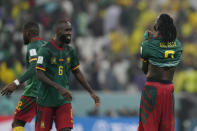 Cameroon players celebrate at the end of the World Cup group G soccer match between Cameroon and Brazil, at the Lusail Stadium in Lusail, Qatar, Friday, Dec. 2, 2022. (AP Photo/Natacha Pisarenko)