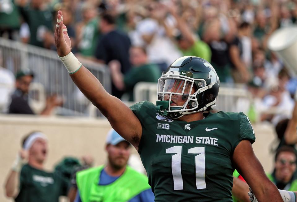 Aug 30, 2019; East Lansing, MI, USA; Michigan State Spartans running back Connor Heyward (11) celebrates a touchdown during the first quarter of a game against the Tulsa Golden Hurricane at Spartan Stadium. Mandatory Credit: Mike Carter-USA TODAY Sports