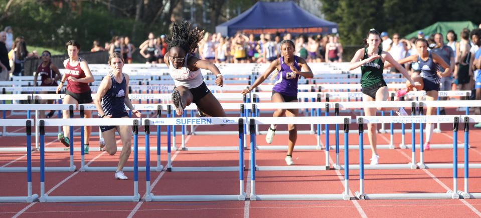 Dami Modupe from North Rockland, third from left, and others compete in the varsity girls 100 meter hurdles during the Mountie Madness Track and Field event at Suffern Middle School, April 14, 2023.
