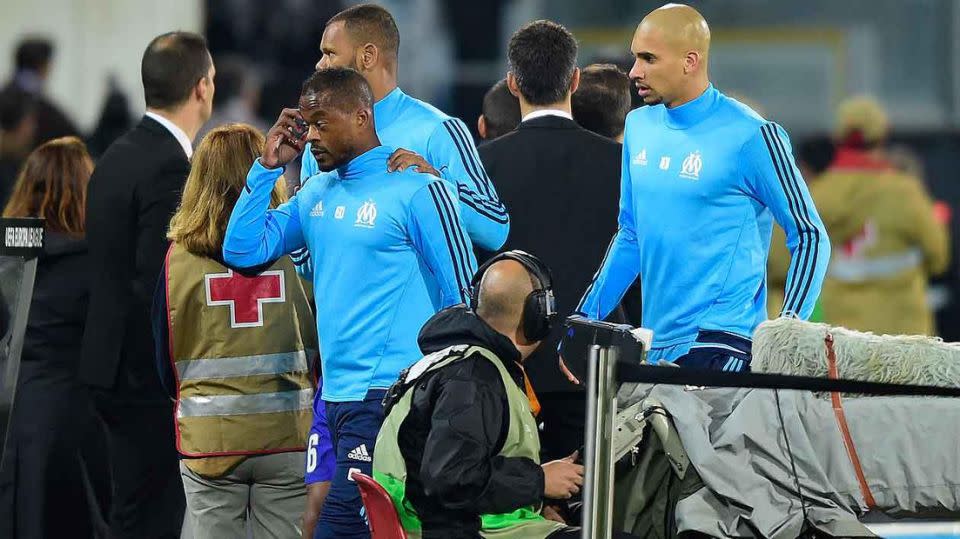 Evra whisked off the field by teammates after the incident. Pic: Getty