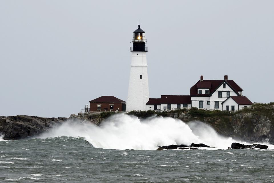 Waves crash against the rocks at Portland Head Light, Saturday, Sept. 15, 2023, in South Portland, Maine. Severe conditions were predicted across parts of Massachusetts and Maine, and hurricane conditions could hit the Canadian provinces of New Brunswick and Nova Scotia, where the storm, Lee, downgraded early Saturday from hurricane to post-tropical cyclone, was expected to make landfall later in the day. (AP Photo/Michael Dwyer)