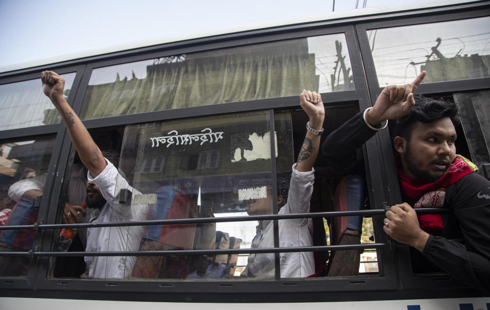 Demonstrators shout slogans after being detained during a protest against the Citizenship Amendment Bill (CAB) in Gauhati, India, Wednesday, Dec. 11, 2019. Protesters burned tires and blocked highways and rail tracks in India's remote northeast for a second day Wednesday as the upper house of Parliament began debating legislation that would grant citizenship to persecuted Hindus and other religious minorities from Pakistan, Bangladesh and Afghanistan. (AP Photo/Anupam Nath)