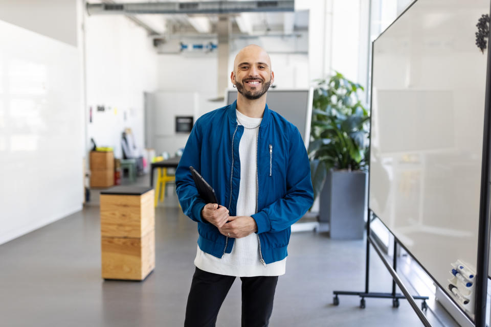 man wearing casual clothes in a tech company office