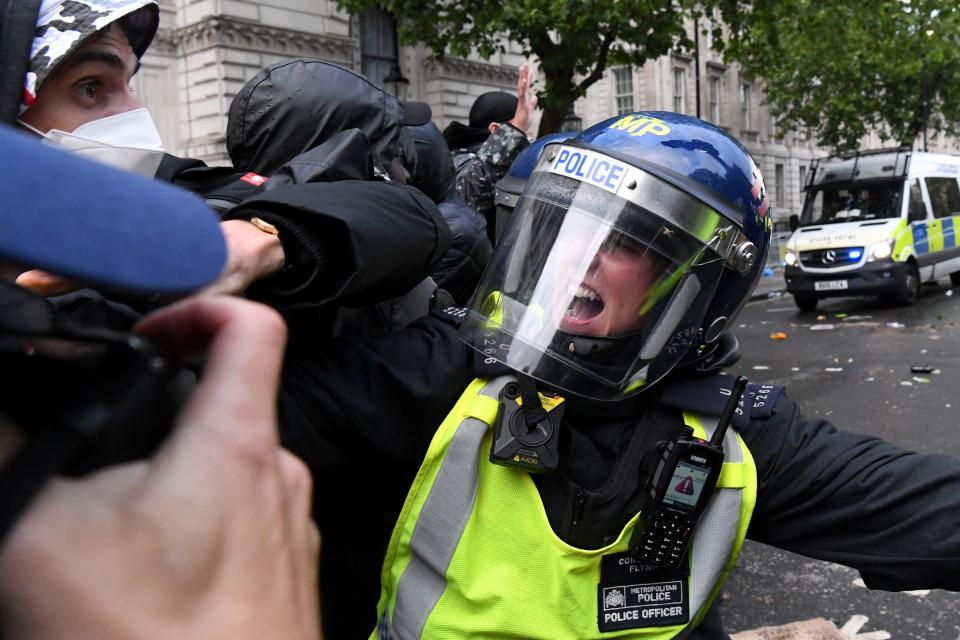 Protestors scuffle with Police officers in riot gear near Downing Street, in central London on June 6, 2020, during a demonstration organised to show solidarity with the Black Lives Matter movement in the wake of the killing of George Floyd, an unarmed black man who died after a police officer knelt on his neck in Minneapolis. - The United States braced Friday for massive weekend protests against racism and police brutality, as outrage soared over the latest law enforcement abuses against demonstrators that were caught on camera. With protests over last week's police killing of George Floyd, an unarmed black man, surging into a second weekend, President Donald Trump sparked fresh controversy by saying it was a "great day" for Floyd. (Photo by DANIEL LEAL-OLIVAS / AFP) (Photo by DANIEL LEAL-OLIVAS/AFP via Getty Images)