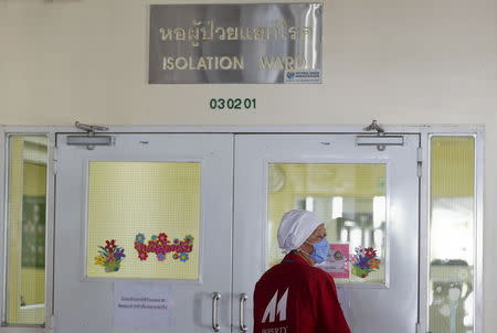 A worker wearing a mask walks outside the isolation ward where a 75-year-old businessman from Oman is being treated for the Middle East Respiratory Syndrome (MERS) at the Bamrasnaradura Infectious Diseases Institute in Nonthaburi province, on the outskirts of Bangkok, Thailand, June 19, 2015. REUTERS/Chaiwat Subprasom