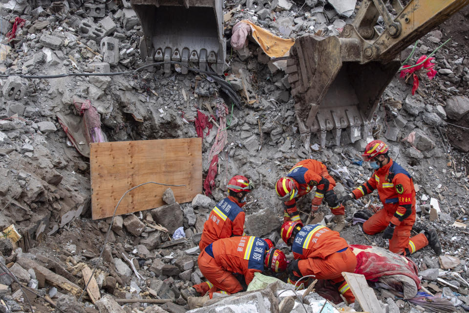 In this photo released by Xinhua News Agency, rescuers carry out operations in Liangshui Village, Tangfang Town, Zhenxiong County, southwest China's Yunnan Province, Jan. 24, 2024. Chinese state media say the death toll from a landslide in the remote, mountainous part of southwestern China has risen while more remain missing. (Jiang Wenyao/Xinhua via AP)