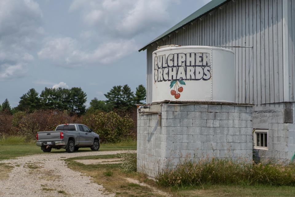 John Pulcipher drives down one of the paths through his family's land at Pulcipher Orchards on Friday, July 14, 2023.