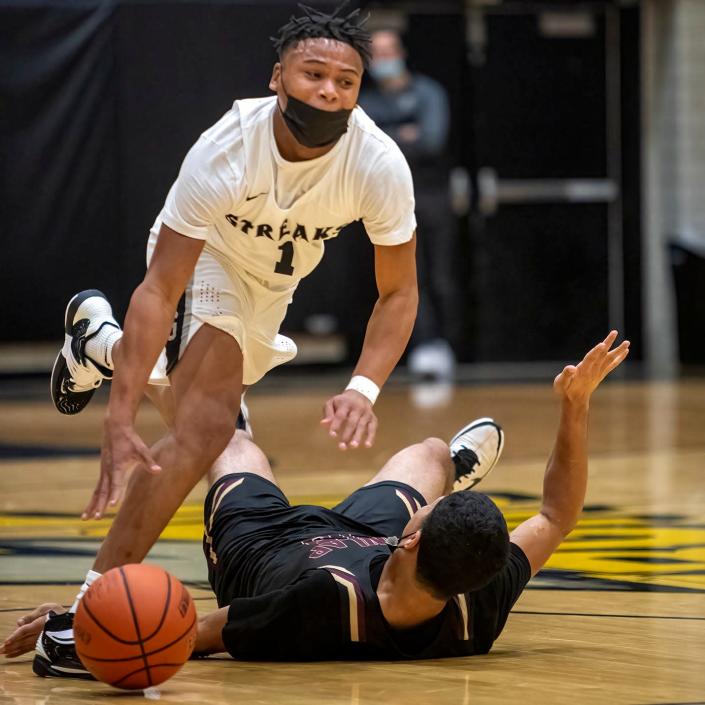 Galesburg senior point guard Jeremiah Babers gets past a Dunlap defender in Thanksgiving tournament acton on  Wednesday, Nov. 24, 2021 at John Thiel Gymnasium.