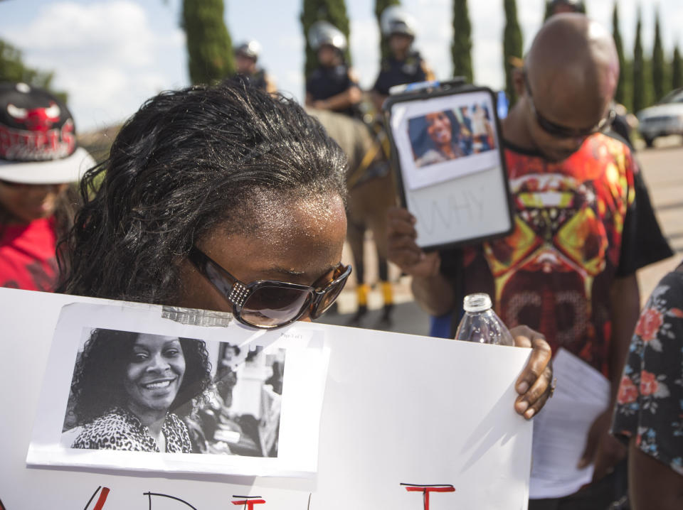 FILE - In this Sunday, July 26, 2015 file photo, Margaret Hilaire bows her head in prayer during a demonstration calling for the firing and indictment of Texas State Trooper Brian Encinia in Katy, Texas. Sandra Bland was found dead in her cell on July 13 in the Waller County Jail, just days after being arrested by Encinia during a traffic stop. Authorities determined through an autopsy that Bland hanged herself with a plastic bag. (Brett Coomer/Houston Chronicle via AP)