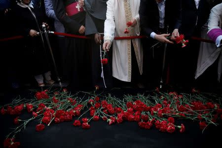 Representatives of various religions and other officials lay carnations during a memorial ceremony for civilians and policemen who were killed while resisting against the coup attempt, on Taksim square in Istanbul, Turkey, July 20, 2016. REUTERS/Alkis Konstantinidis