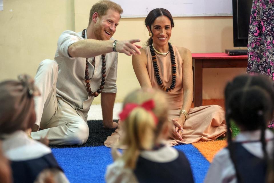 PHOTO: Prince Harry, Duke of Sussex, and Meghan ,Duchess of Sussex, meet with children during their visit at the Lightway Academy in Abuja on May 10, 2024. (Kola Sulaimon/AFP via Getty Images)