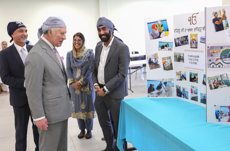 King Charles III speaks to local GPs who ran the Vaisakhi Vaccine Clinic during the Covid 19 pandemic during a visit to the newly built Guru Nanak Gurdwar (Getty Images)