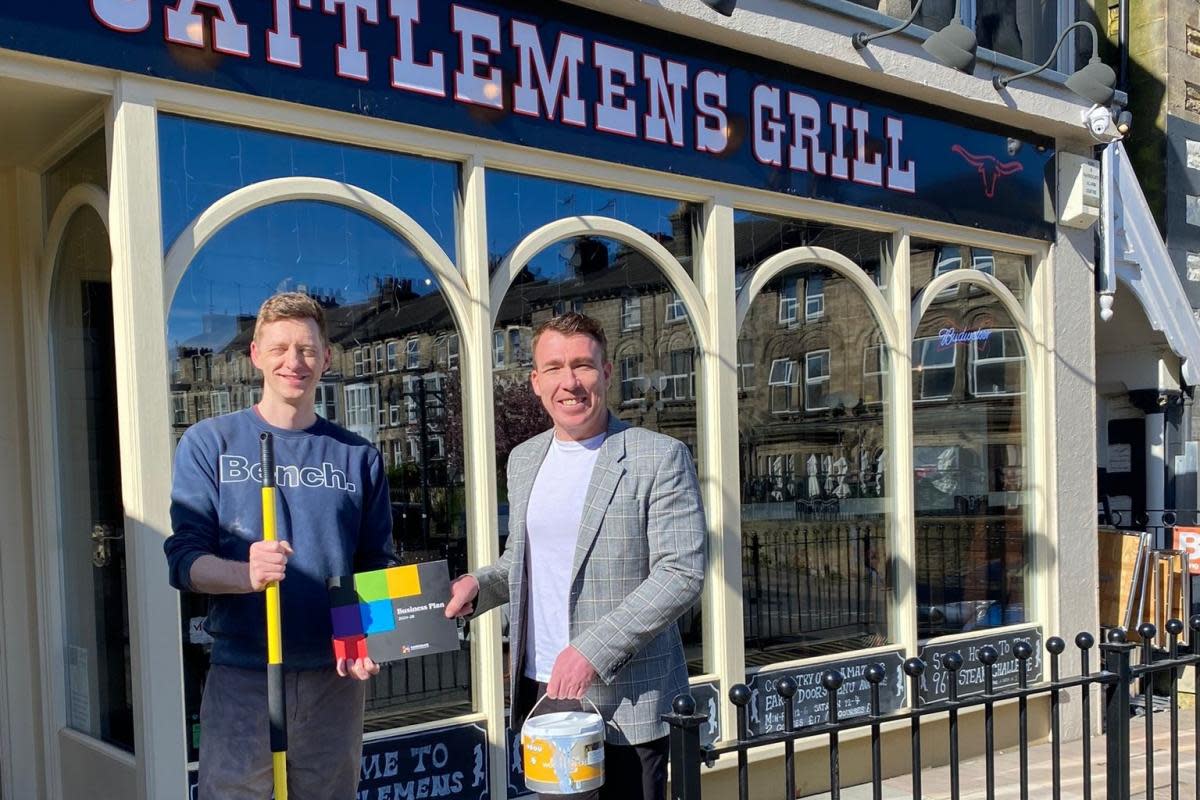 Harrogate BID Manager Matthew Chapman (right) with a staff member from Cattlemen’s Grill, which benefitted from the grant in 2023. <i>(Image: Pic supplied)</i>