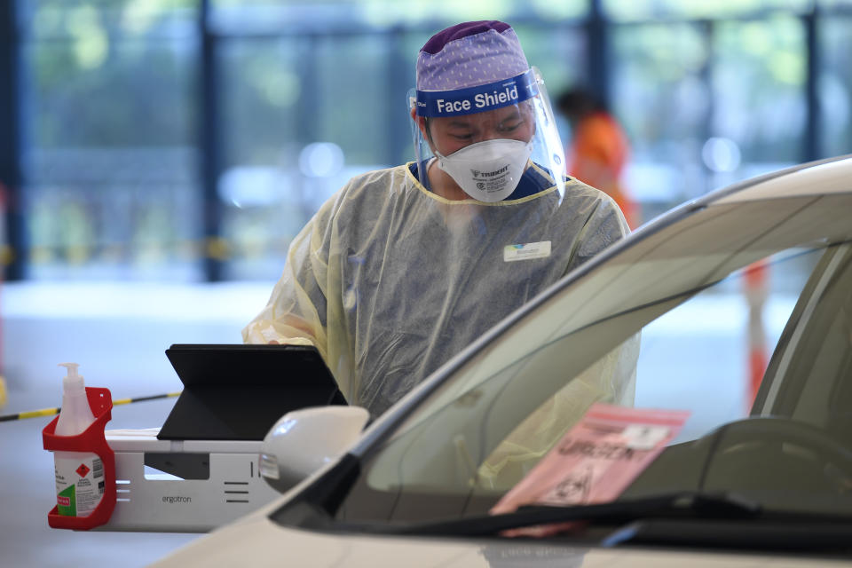 Helathcare worker Brandon Nguyen is seen working at a drive-through Covid19 testing facility in Melbourne, Friday, October 8, 2021. Source: AAP