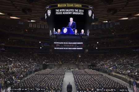 New York City Mayor Bill de Blasio speaks from the podium to the New York City Police Academy Graduating class in New York December 29, 2014. REUTERS/Carlo Allegri