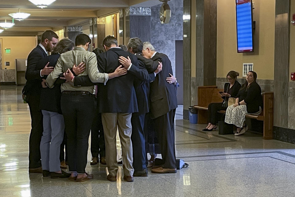 FILE - Covenant School parents and their attorneys huddle in prayer outside a courtroom before a hearing to decide whether documents and journals of a Nashville school shooter can be released to the public Wednesday, April 17, 2024, in Nashville, Tenn. The writings of a person who killed three 9-year-olds and three adults at a private Christian elementary school in Nashville last year cannot be released to the public. A Nashville judge ruled on Thursday, July 5, 2024, that The Covenant School children and parents hold a copyright to the documents given to them by the shooter's parents. (AP Photo/Travis Loller, File)