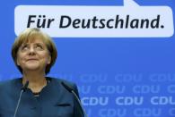 German Chancellor and leader of the Christian Democratic Union ( CDU) Angela Merkel, smiles during a news conference after a CDU party board meeting in Berlin September 23, 2013, the day after the general election. Merkel faces the daunting prospect of persuading her centre-left rivals to keep her in power after her conservatives notched up their best election result in more than two decades but fell short of an absolute majority. REUTERS/Fabrizio Bensch