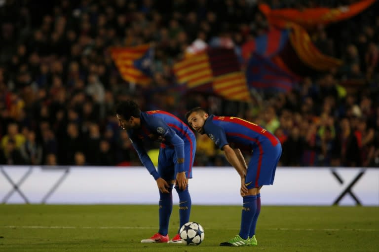 Barcelona's Neymar (L) and teammate Jordi Alba bend over after their UEFA Champions League quarter-final second leg match against Juventus at the Camp Nou stadium in Barcelona on April 19, 2017