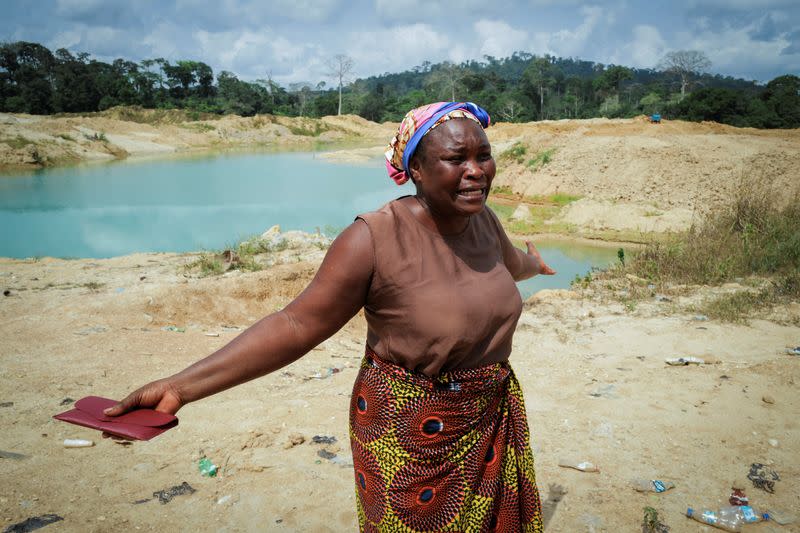 Janet Gyamfi, agricultora de cacao de 52 años, reacciona mientras visita su plantación de cacao destruida por la minería ilegal de oro en la comunidad de Samreboi, en la región occidental de Ghana