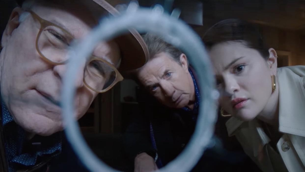  Steve Martin, Martin Short and Selena Gomez looking through bullet hole in window. 