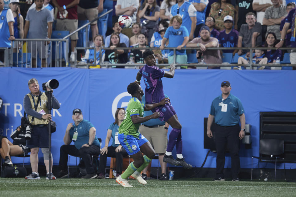 Charlotte FC forward Patrick Agyemang (33) , top center, heads the ball away from Seattle Sounders defender Yeimar Gómez, bottom center, during an MLS soccer match, Saturday, June 10, 2023, in Charlotte, N.C. (AP Photo/Brian Westerholt)