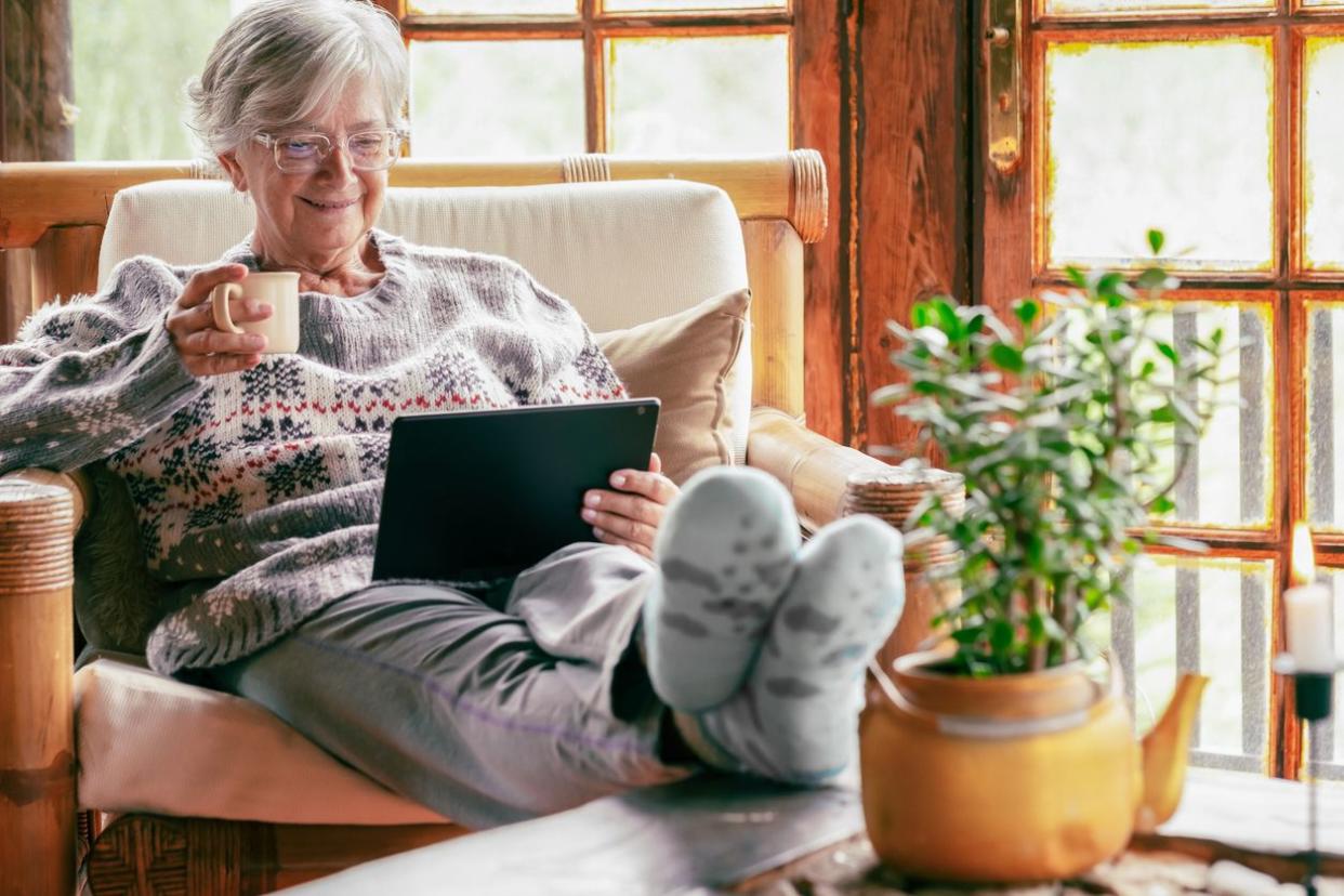 Senior woman at home using a tablet