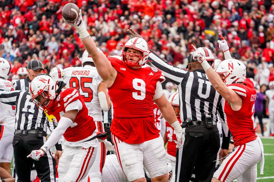 Nov 11, 2023; Lincoln, Nebraska, USA; Nebraska Cornhuskers defensive lineman Ty Robinson (9), linebacker Luke Reimer (4), and defensive back Isaac Gifford (2) celebrate after recovering a fumble against the Maryland Terrapins during the fourth quarter at Memorial Stadium. Mandatory Credit: Dylan Widger-USA TODAY Sports