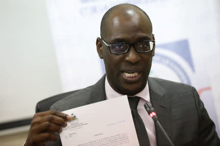 Haiti's Minister of Planning and External Cooperation Aviol Fleurant shows a document after a meeting with Oxfam International Regional Director for Latin America, Simon Ticehurst, and Oxfam Intermon Executive Affiliate Unit head, Margalida Massot, in Port-au-Prince, Haiti, February 22, 2018. REUTERS/Andres Martinez Casares