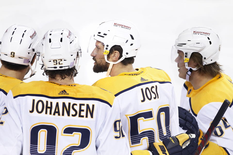 Nashville Predators' Roman Josi, center right, celebrates with teammates after his goal against the Calgary Flames during second-period NHL hockey game action in Calgary, Alberta, Thursday, Nov. 3, 2022. (Larry MacDougal/The Canadian Press via AP)
