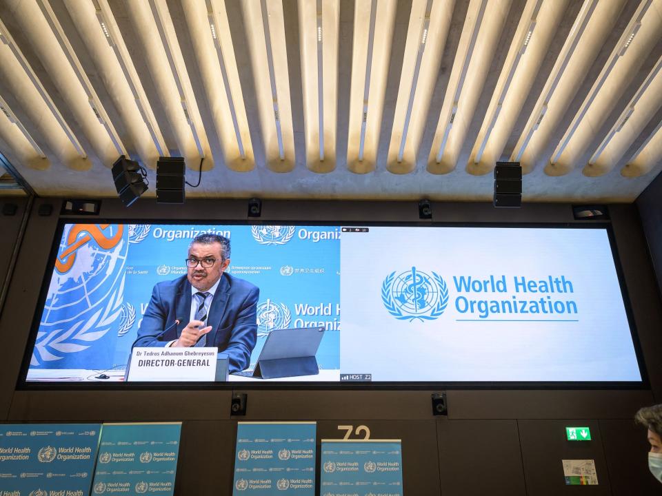 World Health Organization (WHO) Director-General Tedros Adhanom Ghebreyesus is seen on a giant screen during a press conference at the WHO headquarters in Geneva on December 20, 2021.