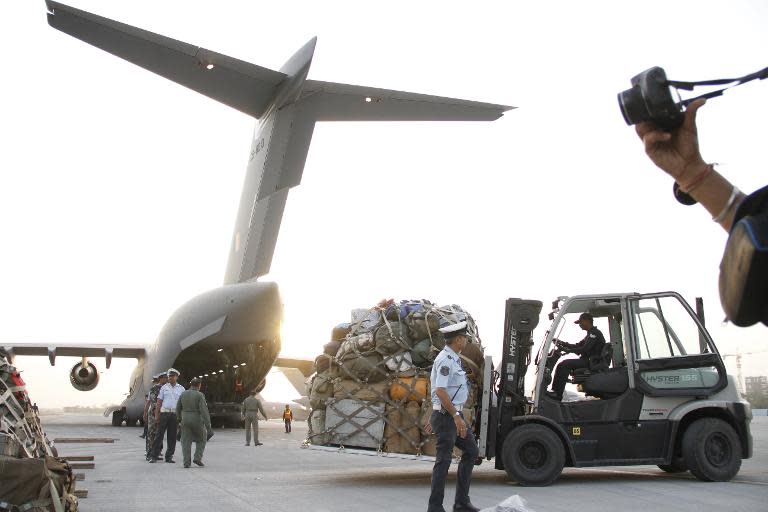 Members of India's National Disaster Response Force prepare relief materials to be airlifted to Nepal to provide assistance to victims of a devastating earthquake, at Hindon Air Force Station near New Delhi on April 25, 2015