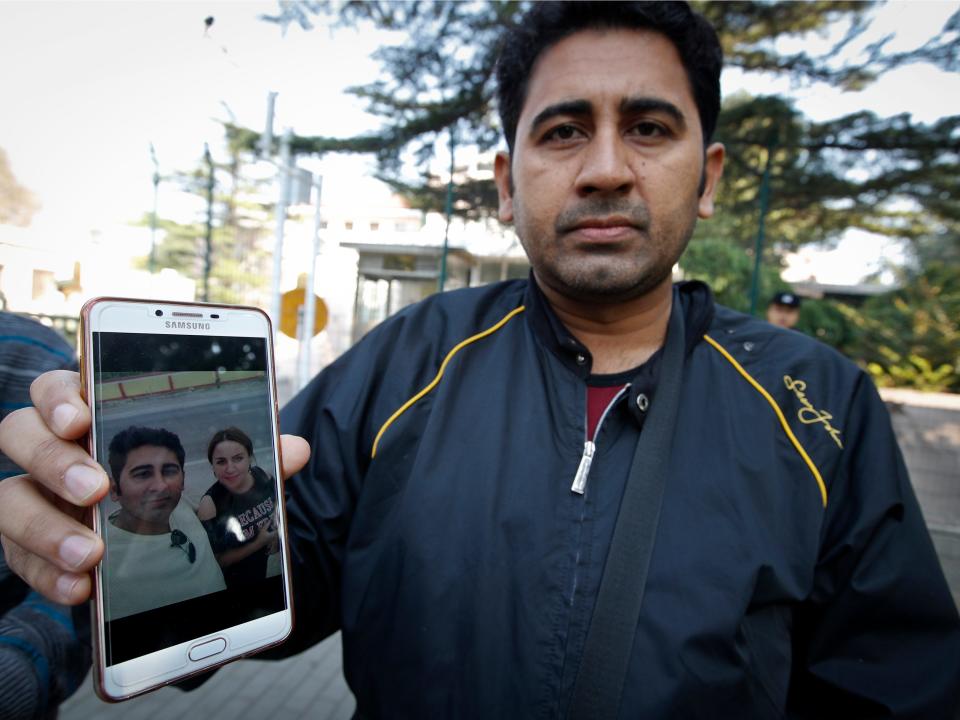 Pakistani man holds photo of Uigher wife interned in Xinjiang