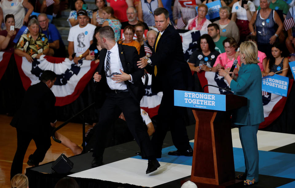 Secret Service officers work to secure area after a protestor jumped into the buffer