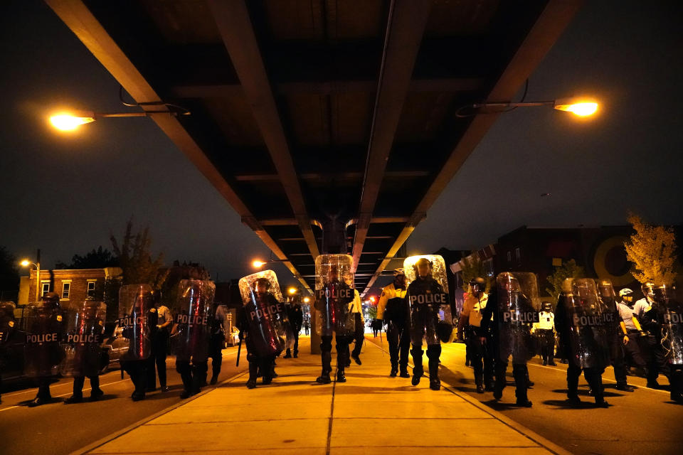 Philadelphia police officers form a line during a demonstration in Philadelphia, late Tuesday, Oct. 27, 2020. Hundreds of demonstrators marched in West Philadelphia over the death of Walter Wallace Jr., a Black man who was killed by police in Philadelphia on Monday. Police shot and killed the 27-year-old on a Philadelphia street after yelling at him to drop his knife. (AP Photo/Matt Slocum)