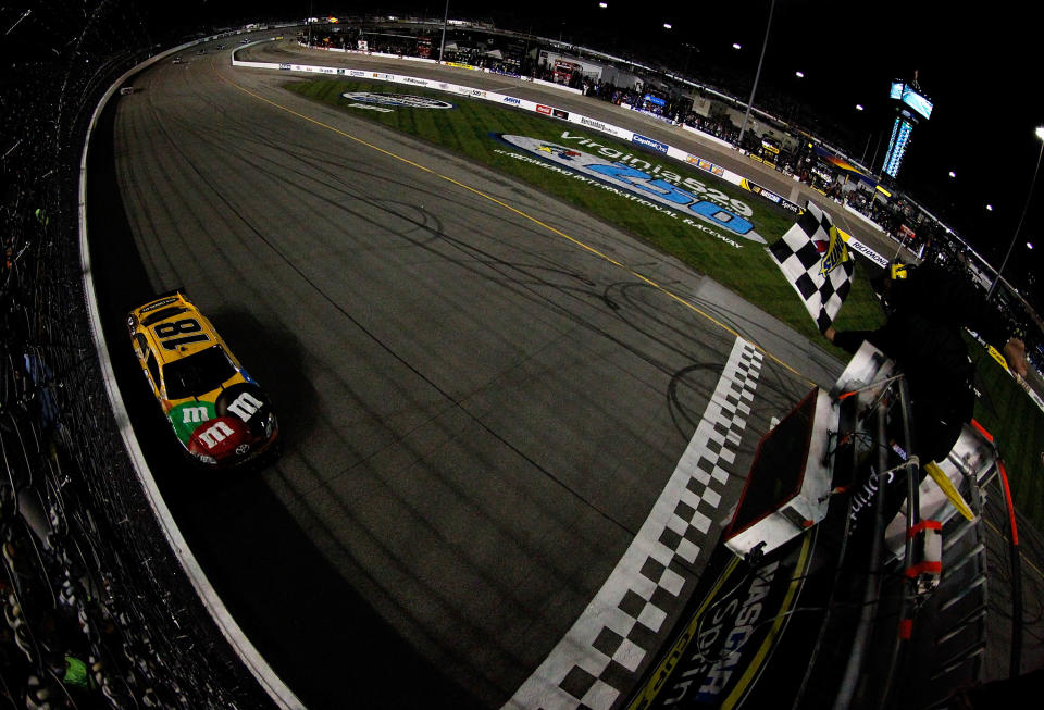 RICHMOND, VA - APRIL 28: Kyle Busch, driver of the #18 M&M's Ms. Brown Toyota, takes the checkered flag to win the NASCAR Sprint Cup Series Capital City 400 at Richmond International Raceway on April 28, 2012 in Richmond, Virginia. (Photo by Tyler Barrick/Getty Images for NASCAR)